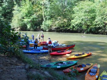 Scene from Chattahoochee Riverkeeper event, with kayaks on riverbank
