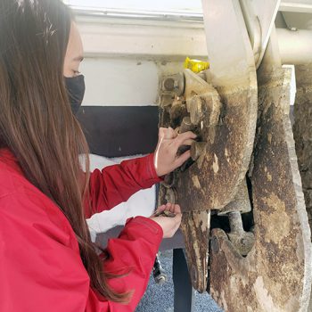 Girl removes invasive Zebra mussels from boat motor