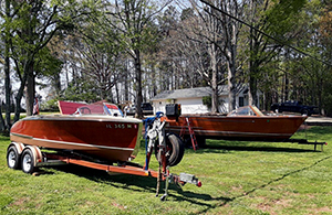 Refinished wooden boats on front lawn