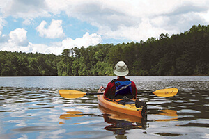 View of Kayaker paddling away