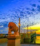 Blue sky and sunrise behind the Bridge of Lions in St. Augustine