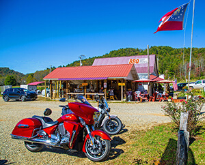 Motorcycle, flag pole and BBQ restaurant