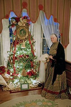Docent in front of Christmas tree