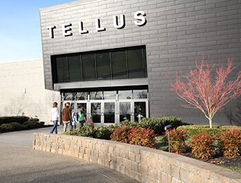 Front of the Tellus Science Museum with people walking toward the building.