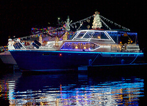 Nighttime view of large boat on Lake Lanier decorated in Christmas lights