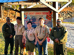 Eagle Scouts in front of life jacket donor station