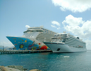 Two cruise ships side by side showing the difference in size - one holds 4,000 passengers, the other 500.