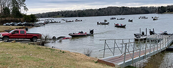 Fishing boats line up in the water to get to boat ramp at the end of the Phoenix Bass Fishing tournament this past February.