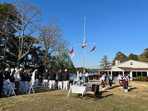 University yacht Club members gather outside for opening day celebration.