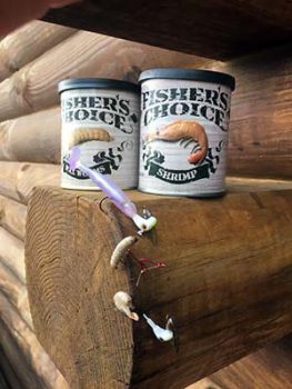 Two cans of Fisher's Choice bait with fishing lewer