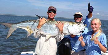 Fishing guide, Mark Noble with clients and their large fish.