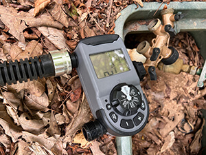 An irrigation timer connected to a water hose.
