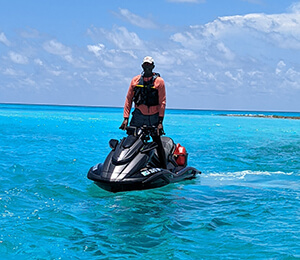 Frank Taylor on his jet ski in blue waters of Bimini.