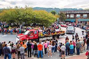 Spectators line the street watching the Apple Festival Parade.