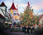 Alpine Helen GA Christmas scene with decorated tree and holiday ights on the buildings.