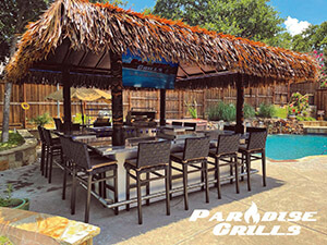 Paradise Grills - outdoor kitchen under thatched roof beside a pool
