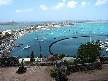 A view of the Saint Martin coastline from land showing a strip of the island and the blue-green ocean.