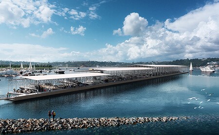 A new, long, covered, breakwater dock with white top, blue sky in background and clear lake water in foreground.