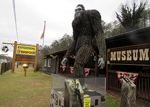 The outside of the Expedition Bigfoot! museum with a large bigfoot statue.