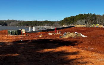 Lake Lanier in the background with blue skies, Georgia red clay with footings for the new LLOP Boathouse.