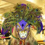 A person wearing a large peacock feather Mardi Gras mask.