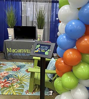 Small section of a room with balloons, Margaritaville carpet, and brochures about Lake Lanier.