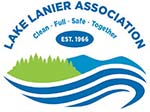 New Lake Lanier Association logo with blue lettering, graphic of green trees, blue mountains and darker blue water.