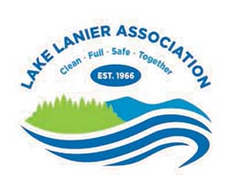 Lake Lanier Association logo in blue and green with water wave in dark blue, mountains in light blue and trees in green.
