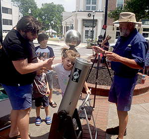 Robert Webb, one of the founders of the Scale Model of Our Solar System, assists star trekkers safely viewing the real Sun on a Hydrogen-Alpha telescope.