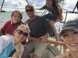 Captain Ricki Lee with his family aboard his sailboat.