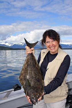 Kathy Watts holding a large halibut..