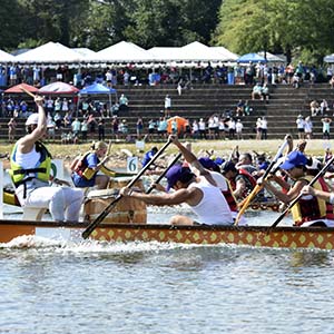 Team drummer, shown on left is at head of Dragonboat to help rowers keep rhythm.