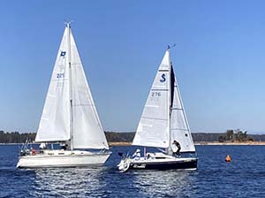 Two white sailboats near a turning mark during the Lanier Cup race.