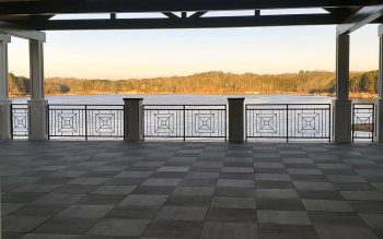 View standing on the boathouse covered deck looking out at Lake Lanier with lake and trees in background.