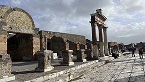 A line of ruins with domed arches and pillars.