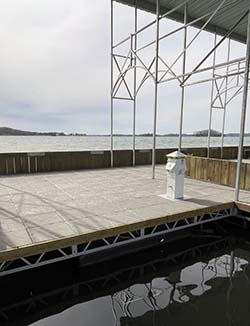 A photo of the new breakwater dock showing the decking, roof and lake. 