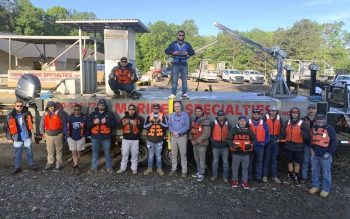 An outside photo of Marine Specialties employees all wearing life jackets.