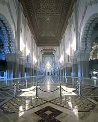 A long view inside the mosque with light flooding in from the top.
